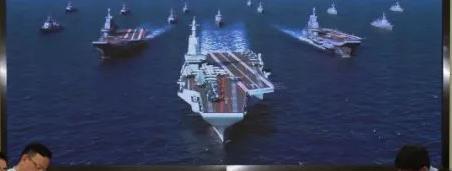 七〇一所会议室背景上的新型国产航母效果图 图片来源：中船重工官方微信