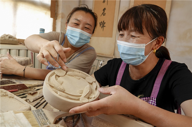 婦女在指導下學習澄泥硯制作技藝。